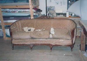 severely damaged and weathered couch