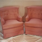 a pair of sweetheart chairs reupholstered in pink fabric