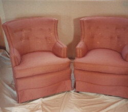 a pair of sweetheart chairs reupholstered in pink fabric