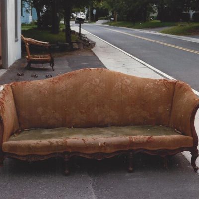 severely damaged vintage couch before repairs
