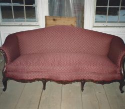 Vintage couch with maroon fabric after repairs vintage couch with maroon fabric